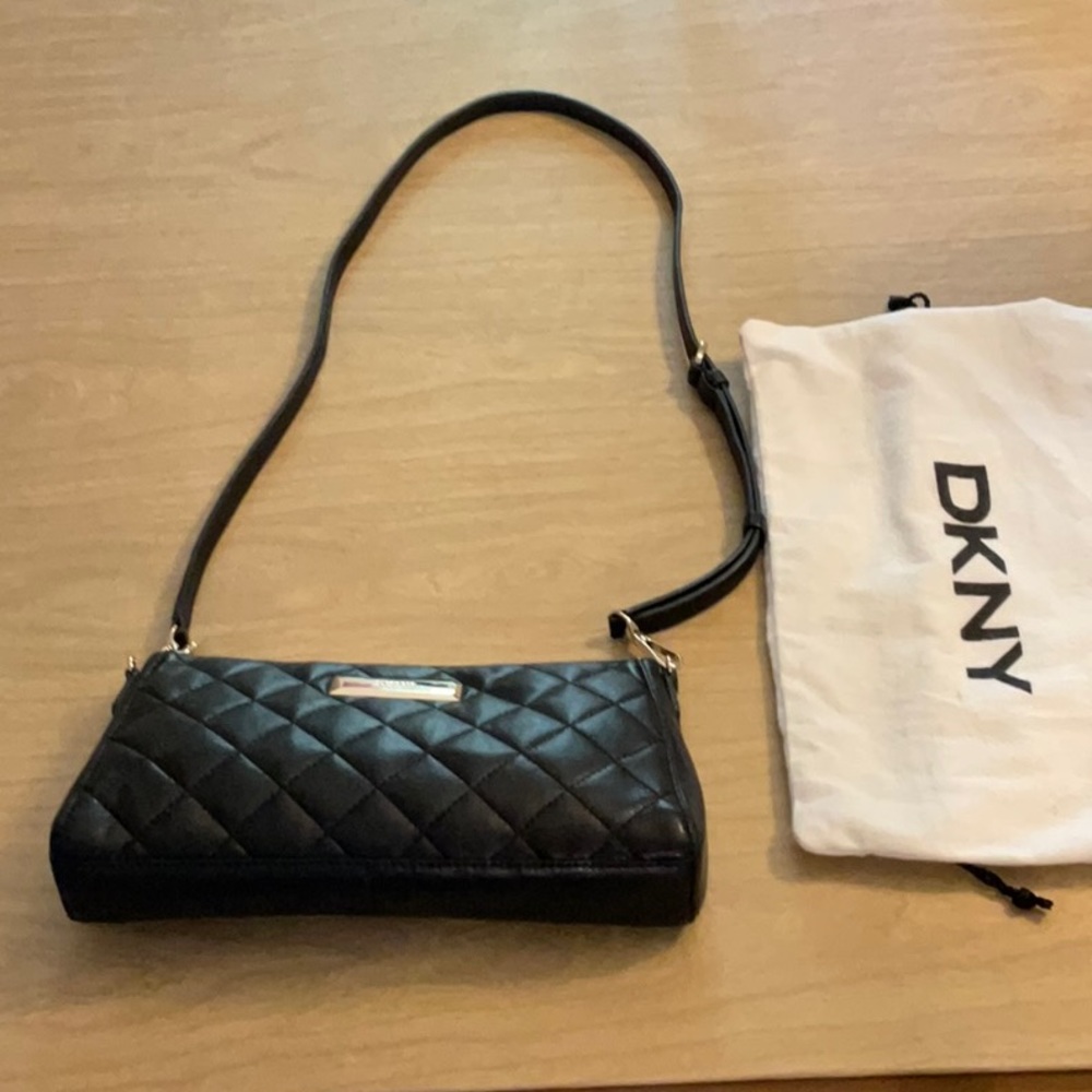 DKNY Black Leather Bag with Dustbag. Interior has 3 Pockets; 1 is Zippered.